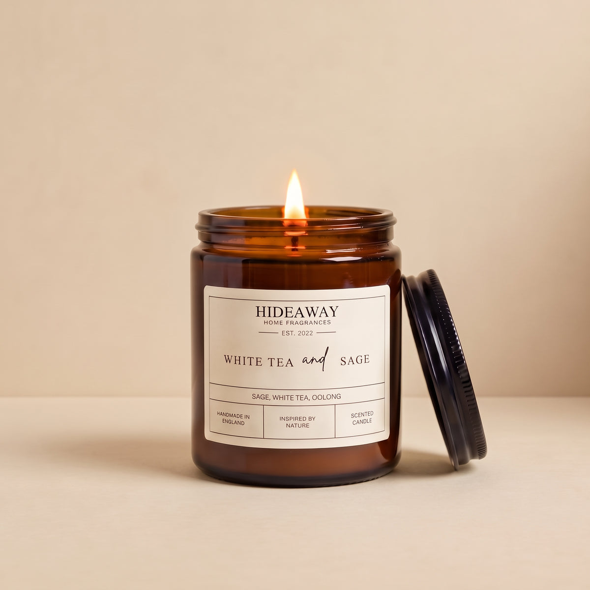 Hand-poured white tea and sage amber glass candle featuring notes of delicate white tea leaves and earthy garden sage, Hideaway Home Fragrances