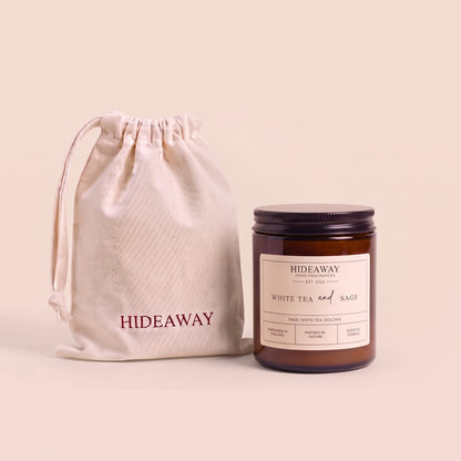 Tranquil white tea and sage aromatic candle in an amber glass jar creating a spa-like relaxation atmosphere from Hideaway Home Fragrances
