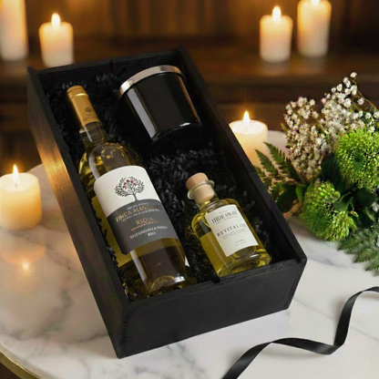 Wick, Reed & Vine Gift Box featuring Finca Manzanos wine, Hideaway glass candle, and reed diffuser inside a black wooden case.