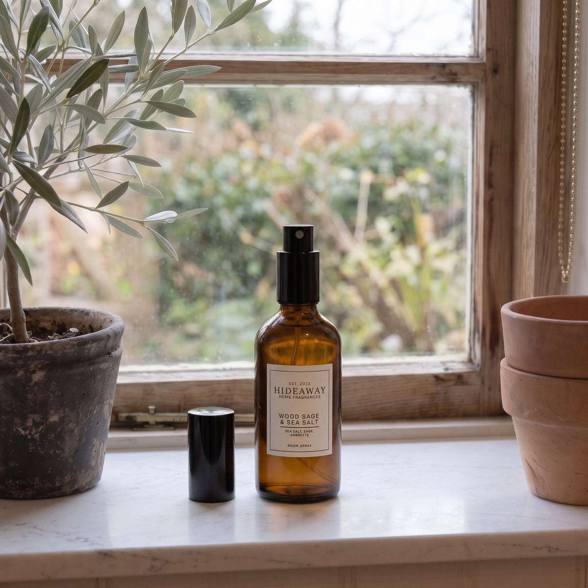 Fragrance notes breakdown for Hideaway Home Fragrances wood sage and sea salt room spray featuring ambrette seeds, crisp sea salt, earthy sage, and cedarwood.