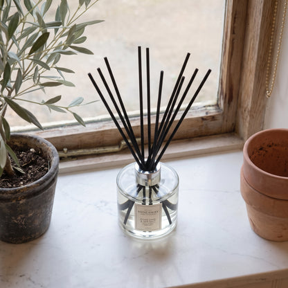 Wood sage and sea salt reed diffuser by Hideaway Home Fragrances featuring ambrette, ozone, and ambergris