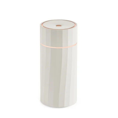 Detailed close-up of one-touch button interface and minimalist matte casing on the Nomad aroma diffuser from Hideaway Home Fragrances