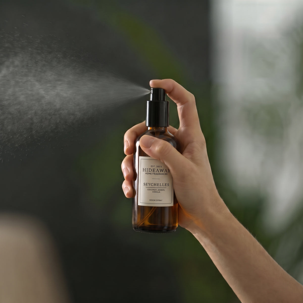 Macro view of the label typography and fine mist spray nozzle on the Hideaway Home Fragrances seychelles room spray bottle.