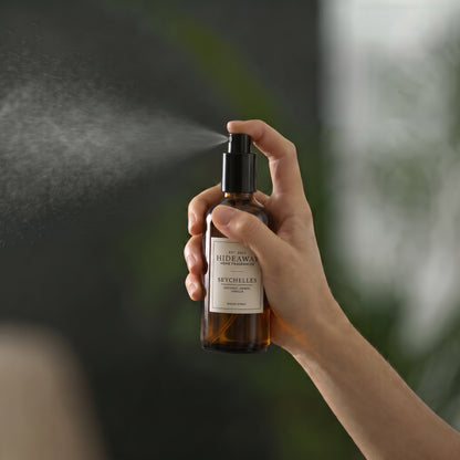 Macro view of the label typography and fine mist spray nozzle on the Hideaway Home Fragrances seychelles room spray bottle.